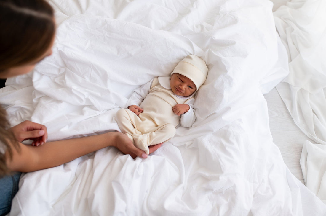 Newborn baby wearing Baby Fil Pima cotton footie and hat – newborn baby clothes available in Preemie, Newborn and 0–3 Months