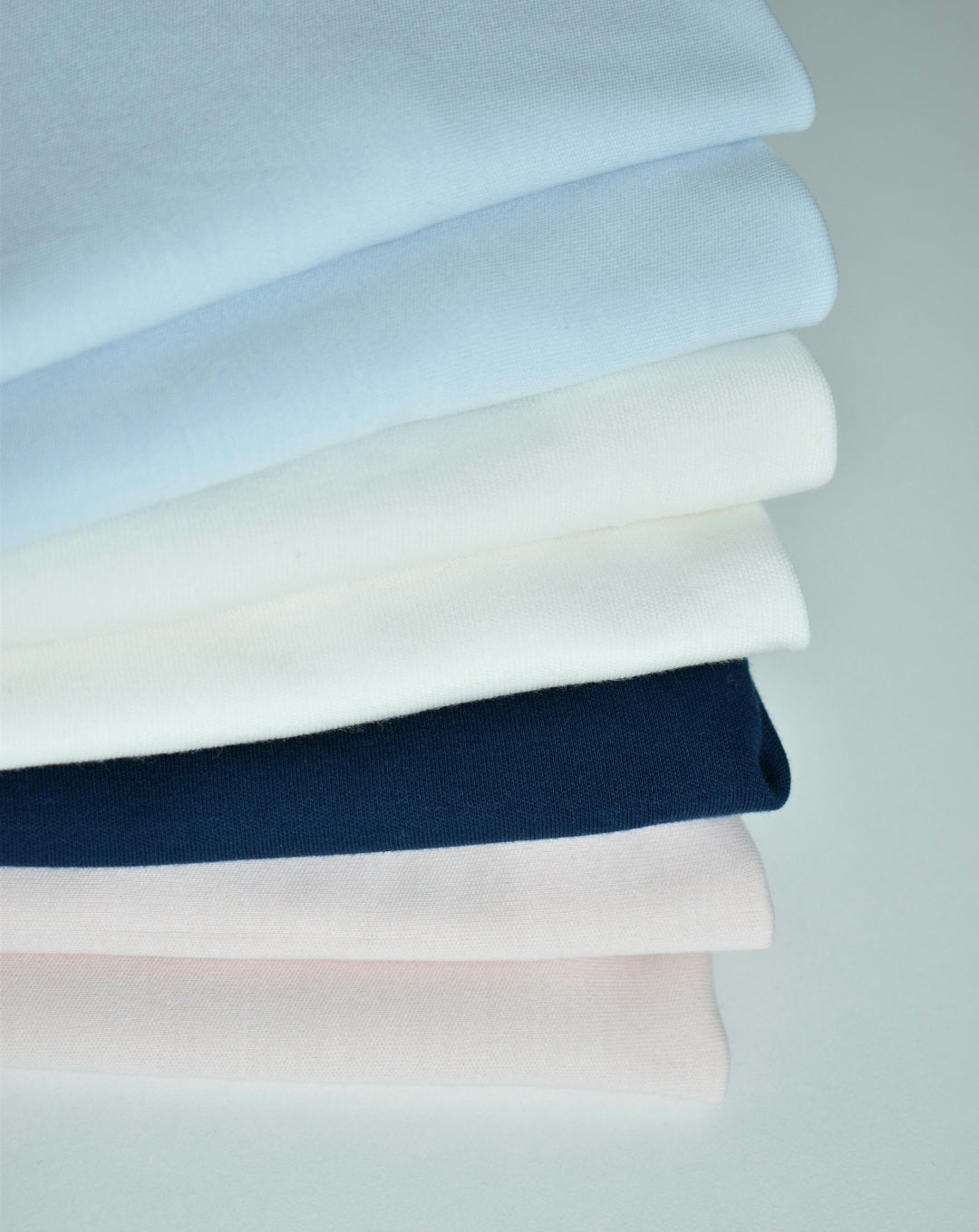 eruvian Pima cotton baby fabrics in soft pink, ivory, blue and navy for newborn clothing.