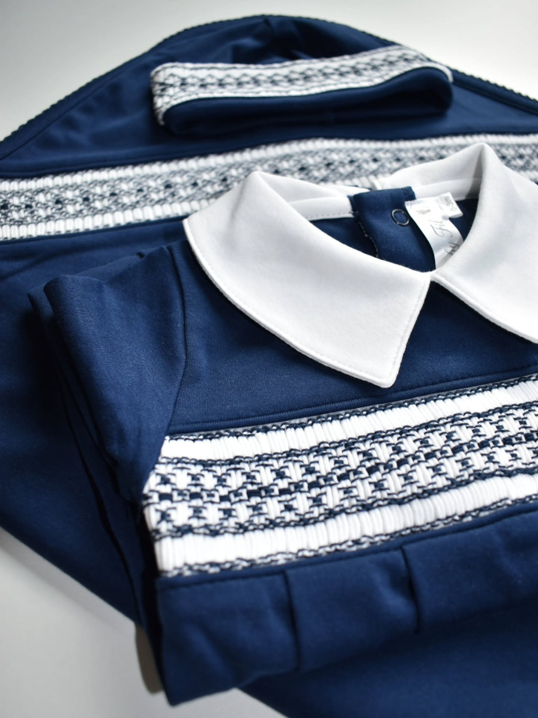 Navy three-piece Peruvian Pima cotton newborn set with footie, hat and blanket with hand-smocked details by Baby Fil